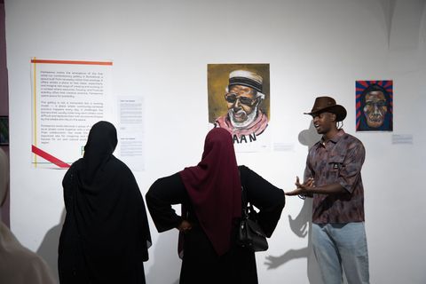 Artist explaining his painting to visitors