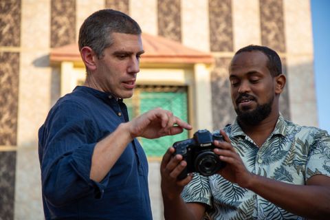Trainer and participant checking a camera