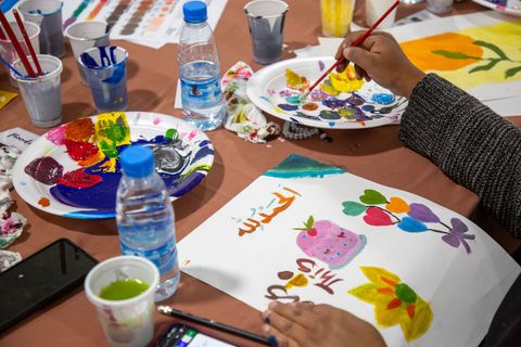 Painting at a table in the ateliers