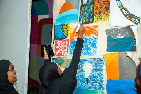 Participant adding to the painted wall at night