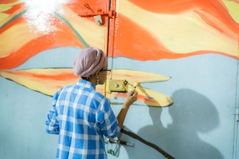 Artist painting a mural