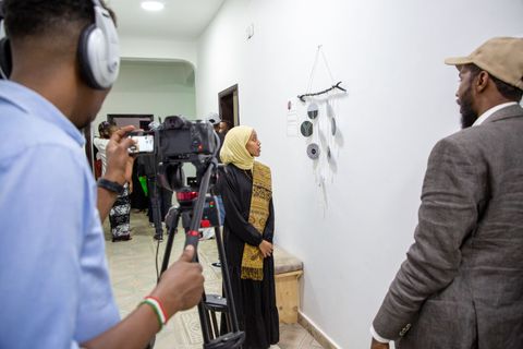 Videographer filming at an exhibition opening