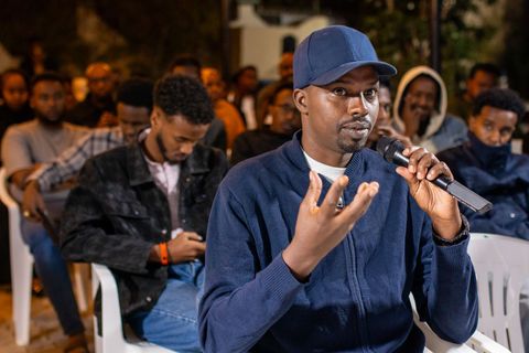 Young man in the audience speaking into a microphone
