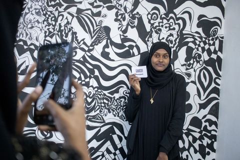 Portrait in front of a patterned wall