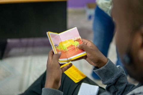 Reading a small handmade book