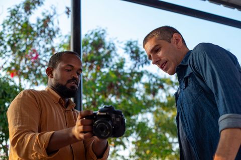 Photography trainer showing a participant the camera