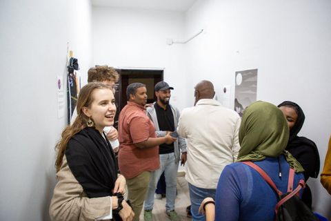 Guests talking at an exhibition opening in the gallery