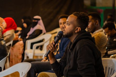 Audience member asking a question into the microphone