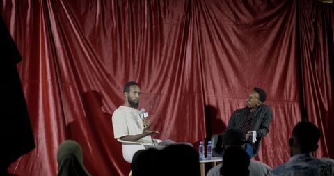 Filmmaker talk on the red-curtain stage at the 2nd Fankeenna Film Fest
