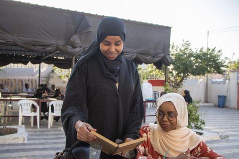 Two visitors reading together