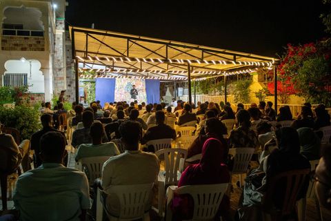 The courtyard at night, full for the open mic