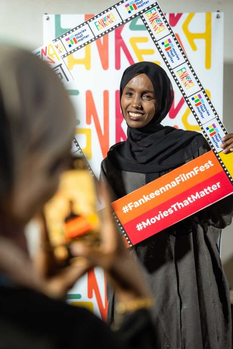 A guest smiling in the Fankeenna Film Fest photo frame