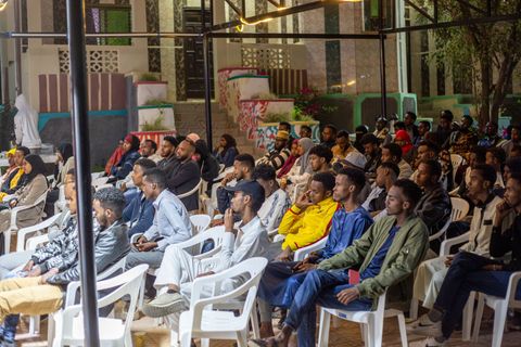 Audience at a recording in the courtyard