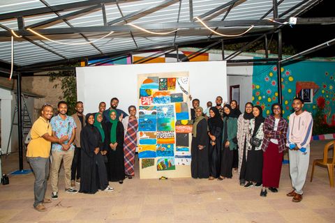 Art therapy workshop participants with their paintings