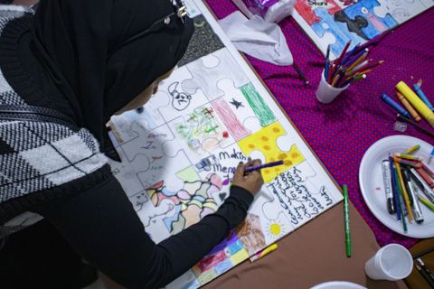 Drawing on a large sheet at the Open House