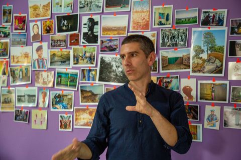 Trainer in front of a wall of photographs